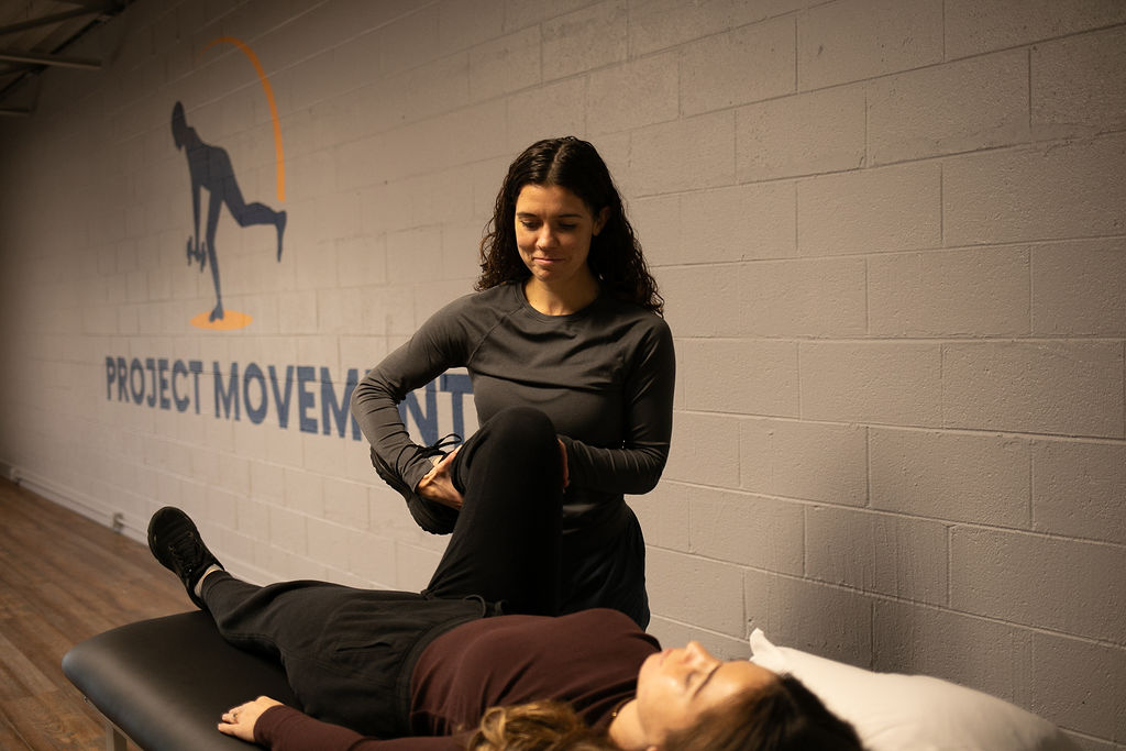 Woman receives stretching treatment from a physical therapist